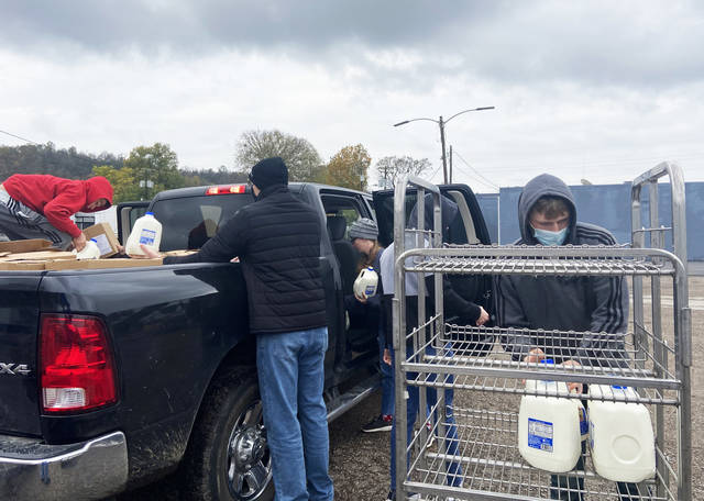 
			
				                                Volunteers load up boxes of food and milk on Friday. The food was handed out to the community for free.
                                 Christy Howell-Hoots, The Ledger Independent

			
		