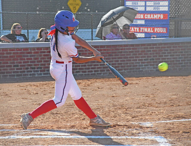 Lewis Countys Alanna Puente drills a two-run single in the first inning of the Lady Lions contest with Lawrence County on Friday, in Vanceburg. (Evan Dennison, The Ledger Independent)