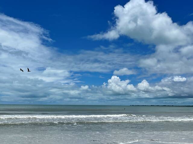 <p>Cloud-dotted blue skies give no hint of the approaching storm in Fort Myers Beach, Florida.</p>