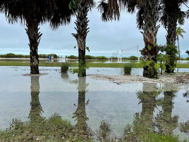 <p>Following the tropical storm, water stands in the sand volleyball court and the area around it on Fort Myers Beach, Florida.</p>