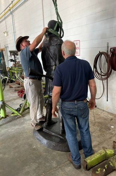 
			
				                                Maysville Public Works Director Dennis Truesdell removed straps used to secure the Kenton scupture during its move while Larry Welker, who cast the statue, looks on.
 
			
		