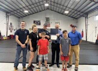
			
				                                Mason County Judge-Executive Owen McNeill and Solid Waste Director Shane Taylor presented a spirit of Mason County certificate of appreciation to Life’s Ultimate Martial Arts Academy for their 100-mile roadside cleanup.
                                 Lauren Tatman/The Ledger Independent

			
		